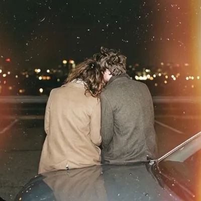 Couple from behind city lights